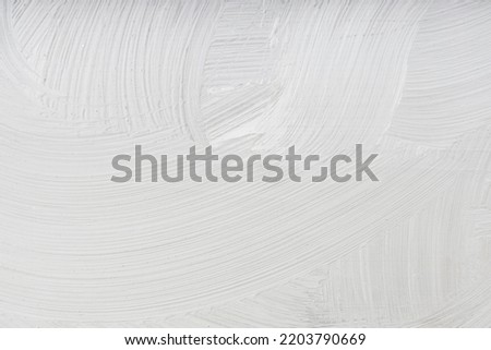 lines of paint on a gray surface, background of paint on the wall. uneven gray color