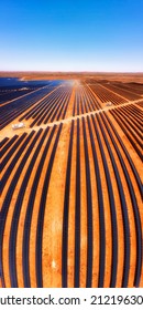 Lines Of Solar Panel Elements Of Broken Hill Solar Plant On Red Soil In Australian Outback - Vertical Aerial Panorama.