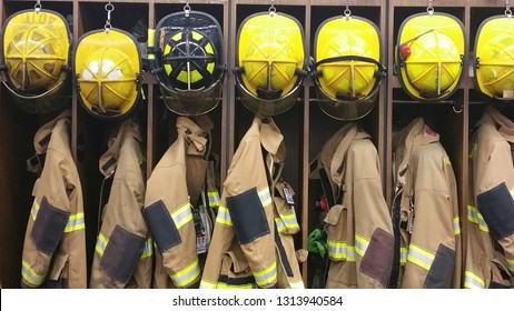 A lineup of firemen’s helmets and turnout gear in a  locker at a volunteer fireman’s station