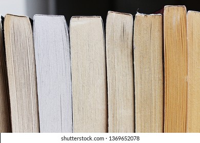 lineup of paperback books in varying shades of yellow