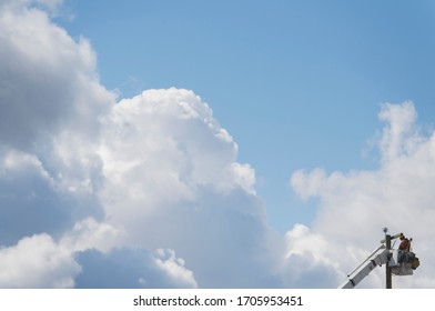 A Lineworker Is Shown Working On A Utility Pole 