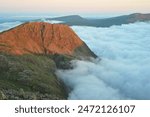 Lingmell catching first light with clouds in the valley near Wasdale. Photographed in June 2024 from Great End