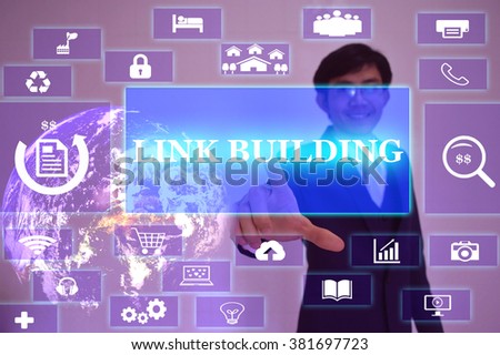 LINK BUILDING concept  presented by  businessman touching on  virtual  screen ,image element furnished by NASA