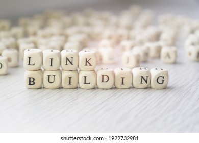 Link Building Words Written In Wooden Cubes Next To A Pile Of Other Letters. Backlinks Concept, Search Engine Optimization, Off-page SEO Term