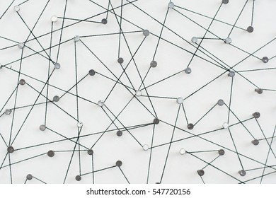 Linking entities, Network simulation, social media, Communications Network, The connection between the two networks. in paper linked together by cotton with a black yarn