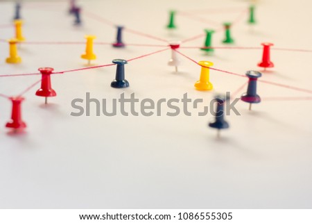 Linking entities, Network simulation, social media, Communications Network, The connection between the two networks. in paper linked together by cotton with a red yarn