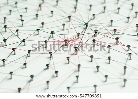 Linking entities, Network simulation, social media, Communications Network, The connection between the two networks. in paper linked together by cotton with a black and red yarn