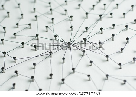 Linking entities, Network simulation, social media, Communications Network, The connection between the two networks. in paper linked together by cotton with a black yarn