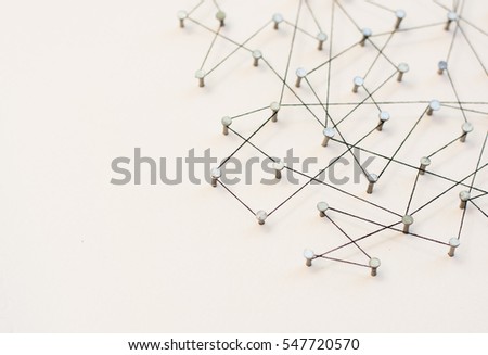 Linking entities, Network simulation, social media, Communications Network, The connection between the two networks. in paper linked together by cotton with a black yarn
