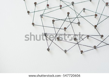 Linking entities, Network simulation, social media, Communications Network, The connection between the two networks. in paper linked together by cotton with a black yarn