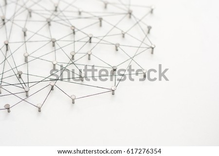 Linking entities, Network simulation, social media, Communications Network, The connection between the two networks. in paper linked together by cotton with a black yarn