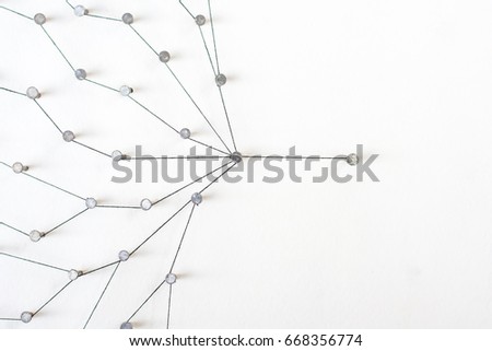 Linking entities, Network simulation, social media, Communications Network, The connection between the two networks. in paper linked together by cotton with a black yarn