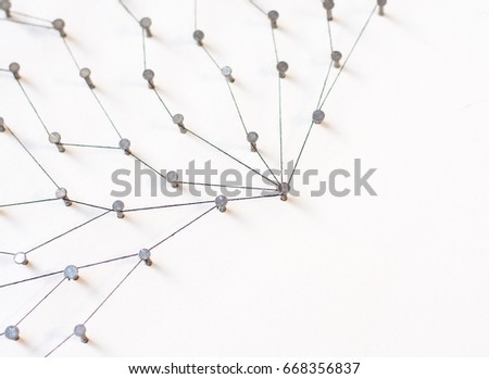 Linking entities, Network simulation, social media, Communications Network, The connection between the two networks. in paper linked together by cotton with a black yarn