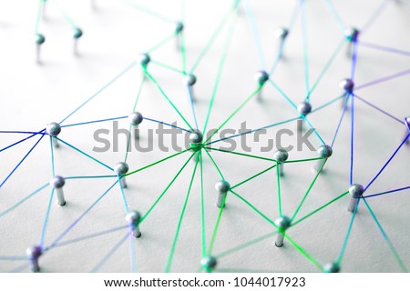 Linking entities. Networking, social media, SNS, internet communication abstract. devices or people connected to a network. Web of green, blue and purple wires on white background. Shallow DOF.