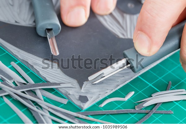 Lino cutting close up. Lino being cut by hand.