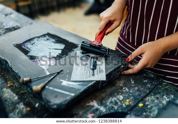 linocut. rolling paint on a piece