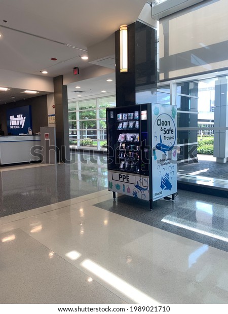 Linthicum Heights, Maryland, US - June 6, 2021:\
modern, glass front Personal Protective Equipment PPE vending\
machine inside the car rental company land transportation terminal\
at BWI airport