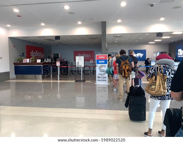 Linthicum Heights, Maryland, US - June 6, 2021:\
Long queue line of travelers waiting inside Dollar and Thrifty\
rental car terminal of BWI airport for any available vehicle due to\
covid shortages