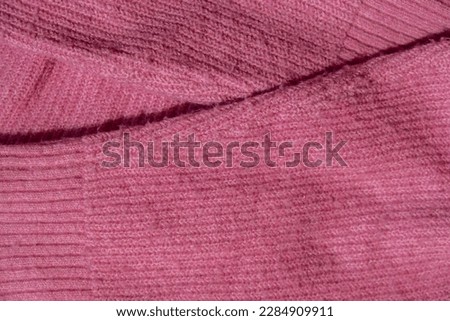 Lints on pink sweater. Acrylic or wool sweater. Before cleaning and collected fluff lint. Closeup Pilled sweater. Old used sweater with lint pilling. Restoration of old damaged clothes care. Repairing