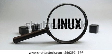 Linux logo viewed through magnifying glass, technology concept focusing on open source software, system analysis, cybersecurity, and IT examination. 