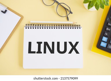 LINUX. Text written in Noebook on light background. Technology concept. Flat lay
