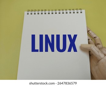 Linux text written on notebook — symbolizing open-source technology, software development, command-line skills, system administration, and flexible operating system environment. 