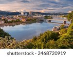 Linz, Austria. Aerial cityscape image of riverside Linz, Austria during spring sunset with reflection of the city in Danube river.