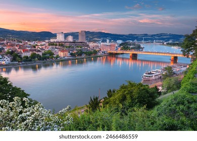 Linz, Austria. Aerial cityscape image of riverside Linz, Austria during spring sunset with reflection of the city lights in Danube river. - Powered by Shutterstock