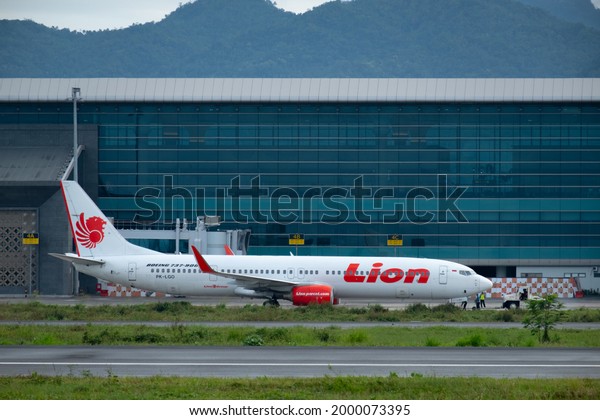 lion air
airplane with push back car in new yogyakarta international airport
with terminal building as background, kulon progo - special region
of yogyakarta : indonesia march 23rd
2021