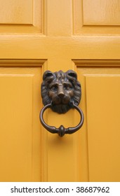 Lion Door Knocker on Bright Yellow Door