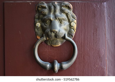 Lion Head Door Knocker on scarlet  background