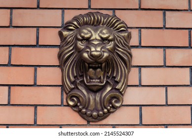 Lion Head Monument On Brick Wall