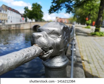 Lion head sculpture on the bank of bruges city