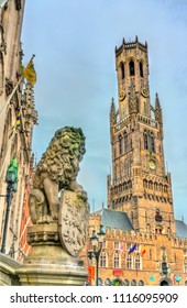 Lion Statue and the Belfry of Bruges, a medieval bell tower in West Flanders Province of Belgium
