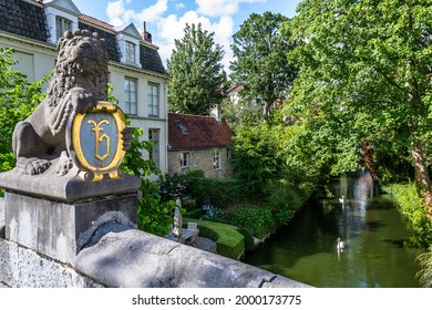 Lion statue with a coat of arms on the Leeuwenbrug (lions' bridge) in the medieval city of Bruges, Belgium