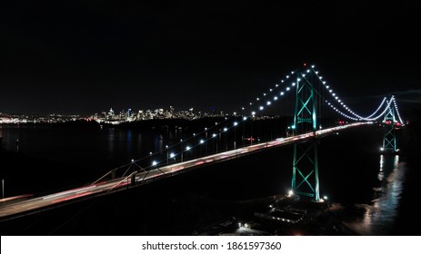 Lions Gate Bridge at night with downtown Vancouver, BC in the background. - Powered by Shutterstock