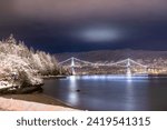 Lions Gate Bridge, Stanley Park, Vancouver, British Columbia. Long Exposure at night in winter with snow.