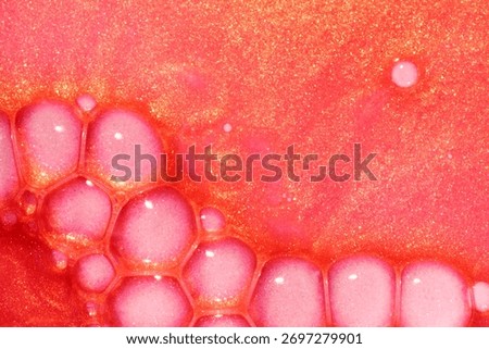 Lip gloss red orange colored with yellow glow shimmering wave textured background