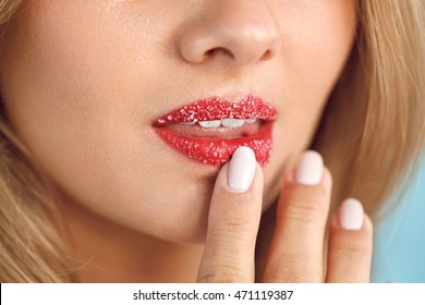 Lip Skin Care. Closeup Of Beautiful Woman's Mouth With Cosmetic Sugar Lip Scrub On. Girl Touching, Exfoliating Her Plump Full Lips Using Scrub To Get Soft Lips. Beauty Concept. High Resolution Image