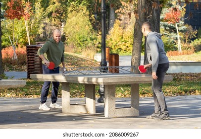 Lipetsk, Russia - 01.11.2021: Two Guys Are Playing Table Tennis Outside In The Park.