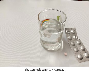 Lipid Lowering Drugs Are Pink And A Glass Of Water .