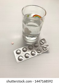 Lipid Lowering Drugs Are Pink And A Glass Of Water .