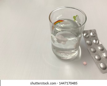 Lipid Lowering Drugs Are Pink And A Glass Of Water .