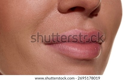 Lips close-up with smooth hydrated surface and soft natural tone. Concept of cosmetic surgery aesthetic clinics, pharma derma cosmetics, beauty skincare, and advertising print packaging.