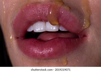 Lips mouth with honey scrub, sugar mask. Lip Scrub. Lips of Beautiful young Woman covered with Sugar, Closeup.