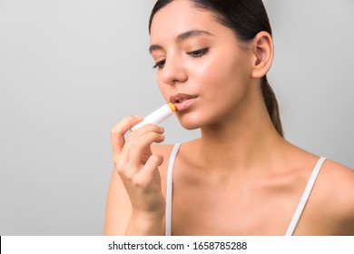 Lips Protection And Care. Beauty Woman Applying Balm On Lips