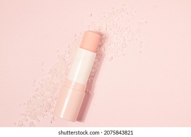 Lips salt balm scrub with salt on pink background, copy space 