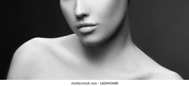 Lips, Shoulders, Part Of Beauty Face Of Model Woman. Perfect Healthy Sin, Nude Natural Make-up. Skincare Facial Treatment Concept. Dark Background. Black And White