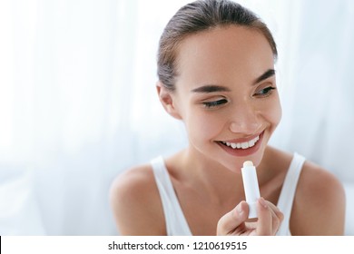 Lips Skin Care. Beautiful Woman Applying Lip Balm. Beauty