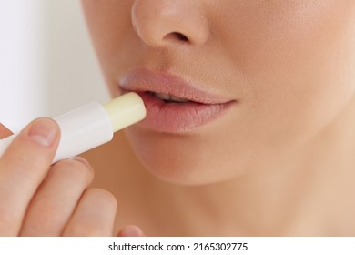 Lips Skin Care. Closeup Of Female Face With Soft Skin Putting Lip Protector Lipstick On. Beautiful Woman Face With Sexy Full Lips Applying Hygienic Lip Balm, Lip Care Stick. Beauty Cosmetics Concept 